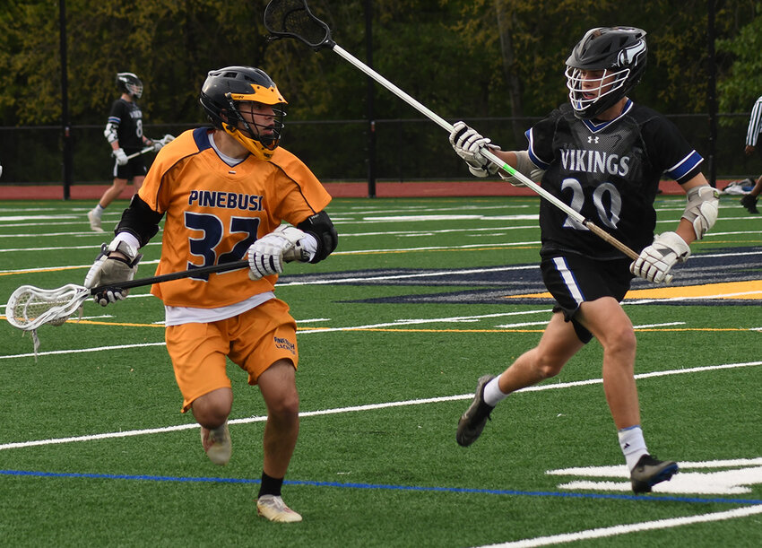 Pine Bush’s Justin Martir runs down the field as Valley Central’s Josh Webb defends during Friday’s Division I boys’ lacrosse game at Pine Bush High School’s Lonergan Field.