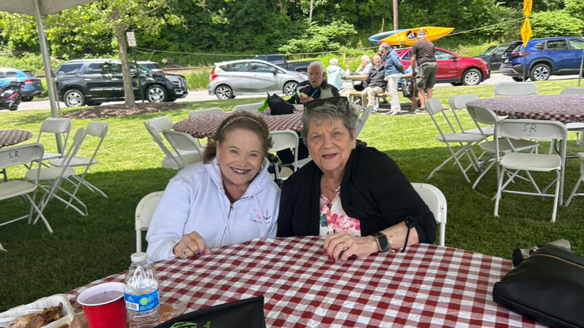 Joy Erreich (left) and Dale Miranda (right) enjoy the sun and the barbecue.