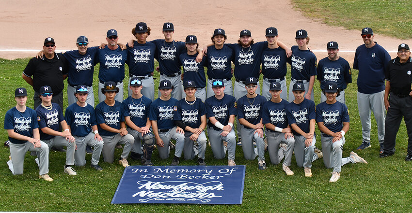 The Newburgh Nuclears players and coaches pose with a banner in memory of longtime general manager Don Becker on Wednesday at Delano-Hitch Stadium in Newburgh.