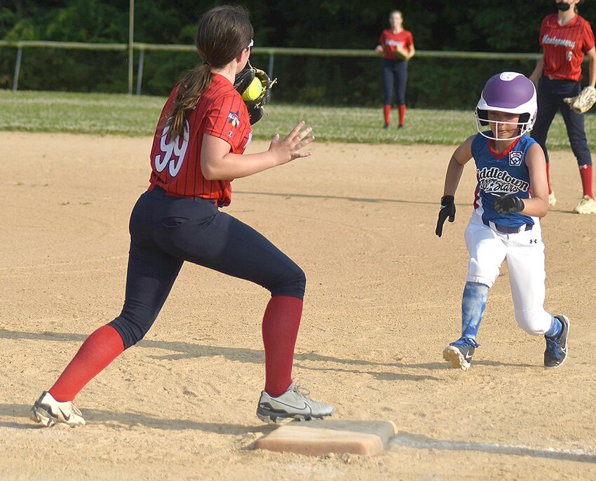 Montgomery first baseman Allison Henrie doubles off a Middletown base runner during a District 19 Majors softball game on June 18 at the Town of Newburgh Little League Complex.