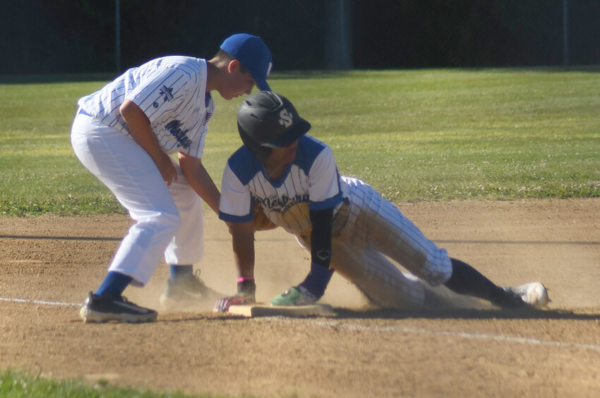 Town of Newburgh’s Jayden Brooks looks for the call after sliding into third base as Montgomery third baseman Cayden Toth applies the tag during a District 19 junior baseball game at Pine Bush Town Park.