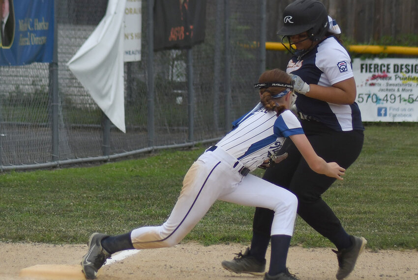 Town of Newburgh third baseman Emily Purcell tags out a Pine Bush runner at third base during Wednesday’s District 19 Minors softball game at Port Jervis Little League.