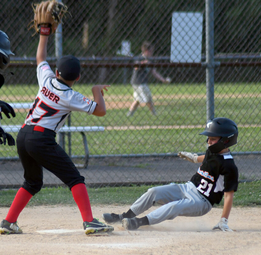 Marlboro Mighty Marlins’ Benjamin Skulky slides into home plate as Hudson Valley Storm’s Ben Auer takes the throw during Friday’s Greater Hudson Valley Baseball League  9U game at the Town of Newburgh Little League Complex.