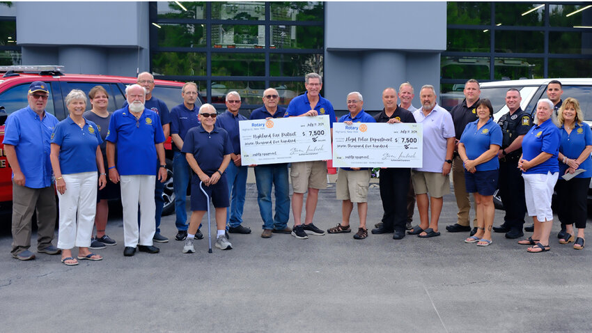 Two checks totaling $15,000 were donated by the Highland Rotary to the Police and Fire Departments to be used for safety equipment. Pictured L-R are Sal Sorbello, Patricia Mikkelsen, Christine LaForge, BJ Mikkelsen, Al Barone, Roger LaForge, Bruce Desmond, Pete Miller, Steve DiLorenzo, Steve Laubach, Pete Fiorese, Chief James Janso, Anthony Giangrasso, Dave Plavchak, Sgt. Roberto, Christine Giangrasso, Detective Lembo, Christine Sorbello, Officer LaDuca and Deborah Laubach.