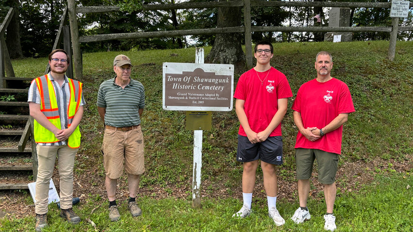 From left to right: Dan Dannor, director of environmental services for C2G; Pete Cocks, Assistant Scoutmaster of Troop 33; Joseph Davis, Troop 33 Life Scout; and Mike Davis, Troop 33 committee chair and Joseph&rsquo;s father. The four stand where headstones will be restored.