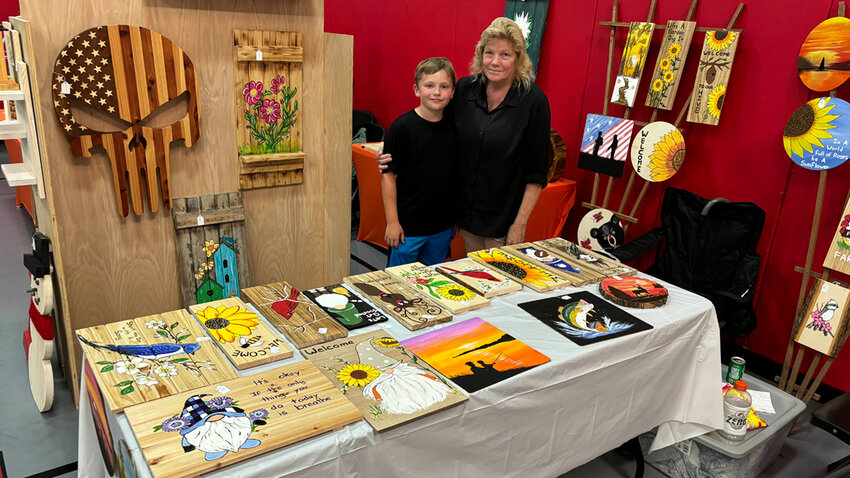 Ann Oundell and Raylan Turner, the former selling wood painting.