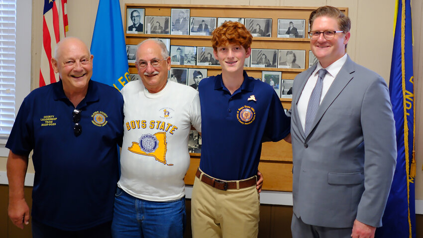 Tom Schroeder, of the Marlborough American Legion [L] stands with three generations of Boys State attendees, [L-R] Dr. Anthony Pascale (wearing his original T-shirt), Christian Pascale and Nick Pascale.