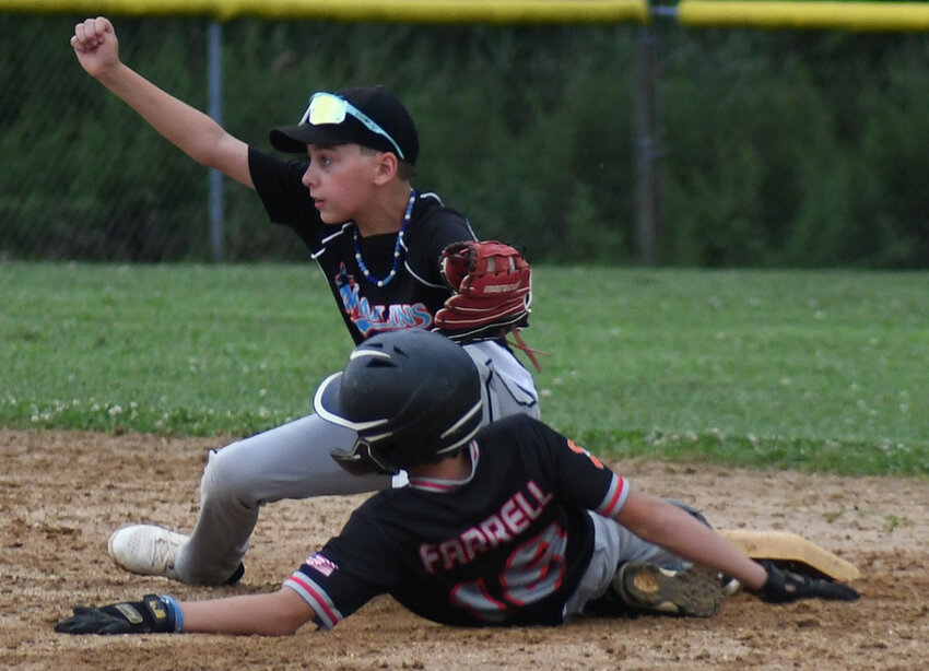 Marlboro Marlins shortstop Justin Cavanagh celebrates the call after tagging out the Hudson Valley Storm’s Braeden Farrell during Wednesday’s Greater Hudson Valley Baseball League 12 game on Wednesday at Town of Newburgh Little League.