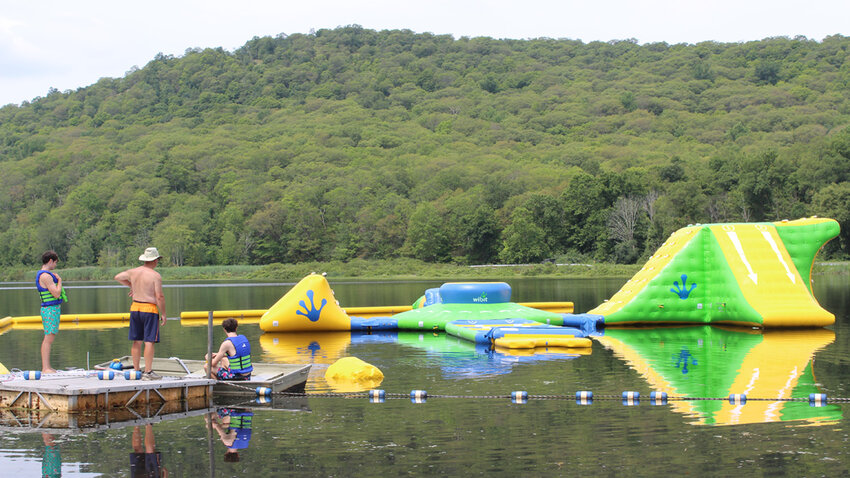 On a recent Saturday morning, Tim Donovan and his crew (John and Pat Flynn) worked to anchor the larger Wibit in Long Pond. For more information on how to play on the structures, visit hudsonskyropes.com.