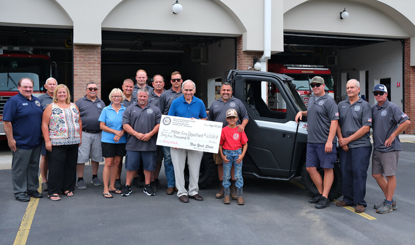 Elected officials and members of the Milton Fire Department pose beside their new UTV vehicle. Pictured L-R Tom Corcoran, Bruce MacElrath, Gina Hansut, Art Tabasco, Janice Appler District Treasurer, Frank Milazzo, Commissioner Neil Fino, Capt. Ryan Lynch, Commissioner Steve Kneeter, Adam Kneeter 3rd Asst. Chief, NYS Assemblyman Jonathan Jacobson, Chief Steve Rivieccio and son Joey, Matt Kneeter 1st Asst. Chief, Commissioner Dick Martin and Gael Appler Jr. 2nd Asst. Chief.