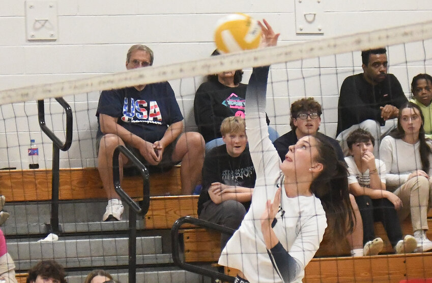 Newburgh’s McKayla Rafferty hits the ball over the net as teammates Megan Evans and Sofia Mucci look on during an OCIAA Division I volleyball match on Oct. 6, 2023, at Newburgh Free Academy’s Main Campus.