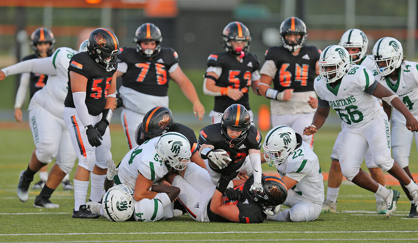 Jack Buzzurro (22) leaps over the pile for a gain of 6, part of his 100 yards for the day.