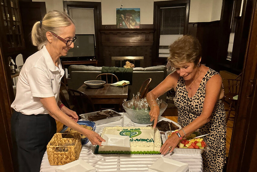 Charlie Murphy-Dadson and Dennis Gibney, both Board of Director members of The Center of Highland Falls, cut the cake at the organization’s 10th anniversary celebration on Saturday evening.