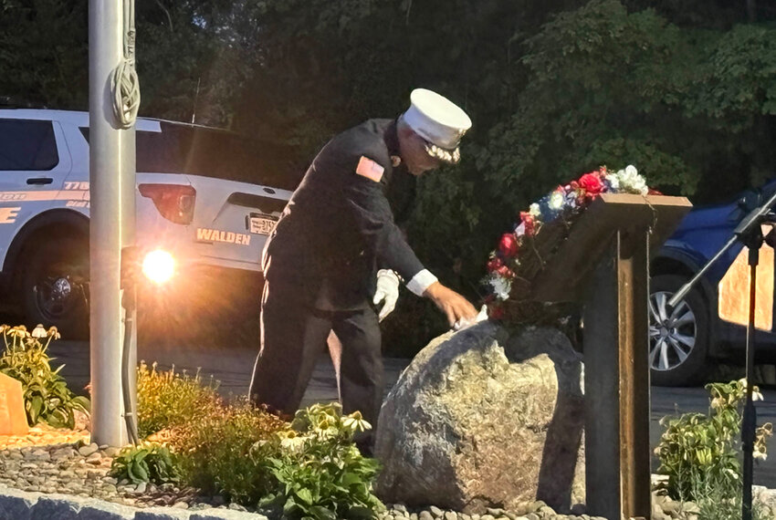 Rev. Jim Van Houten placing his glove on the steal beam memorial during last week’s 9-11 Memorial Service at the Walden Fire House.