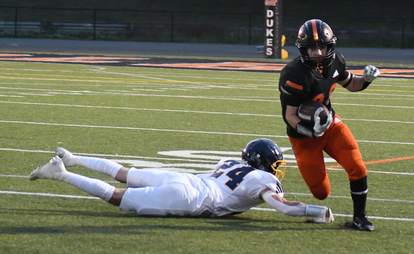 Marlboro’s Jack Buzzurro runs the football as Highland’s Trevor Coates tries to make the tackle during Friday’s Black and Blue Bowl football game at Dennis Burkett Field at Marlboro High School.