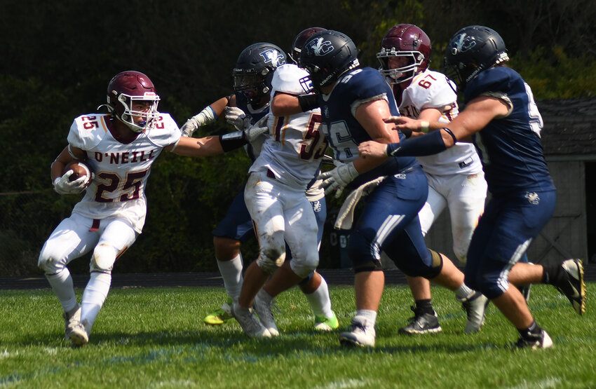 James I. O’Neill’s David Walsh (25) looks for running room during Saturday’s non-league football game at John S. Burke Catholic High School in Goshen.