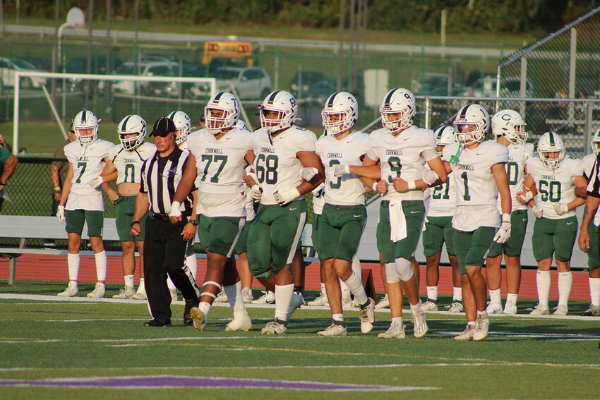 Team captains Isaiah Reyneso (77), Ryan Nunez-Gomez (68), Braden Murphy (3), Quinn Pikarsky (9) and Matthew Cerone (1) walk to the center of the field for the coin flip.