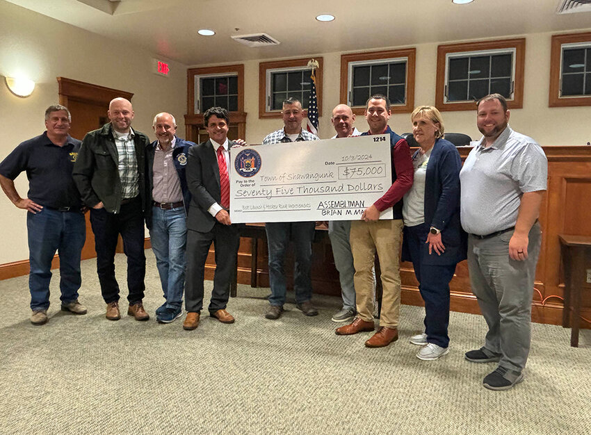 Brian Maher holding up a giant $75,000 check with several Shawangunk officials.