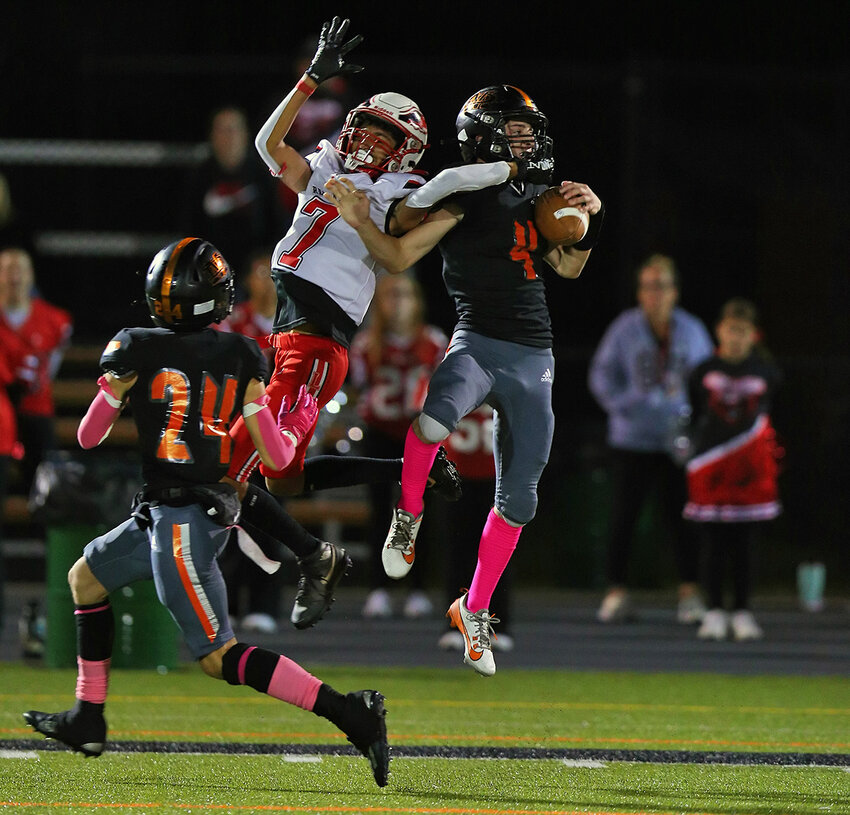 Chris DeNatale (#4) picks off a pass intended for Liberty receiver Aydan Wilson (#7) during the fourth quarter.