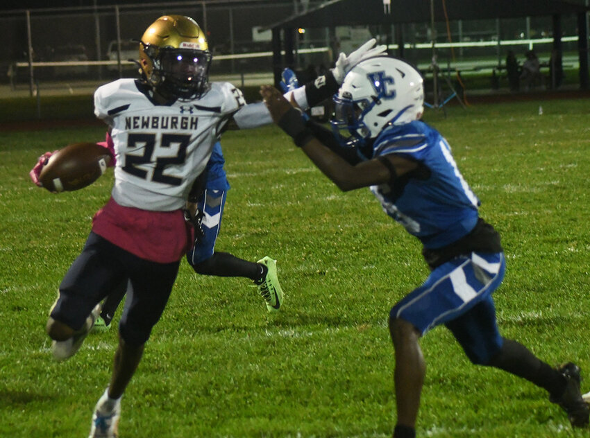 Newburgh’s Michael Chambliss, Jr., runs around the end as he holds off Valley Central’s Ladanein Morrison during Friday’s Class AA football game at Valley Central High School in Montgomery.