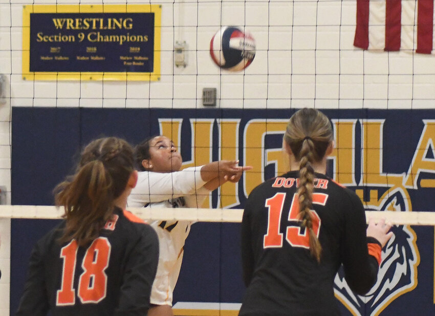 Highland’s Amelia Delforno hits the ball in the air as two Dover players look on during a MHAL Division III volleyball game on Oct. 8 at Highland High School.