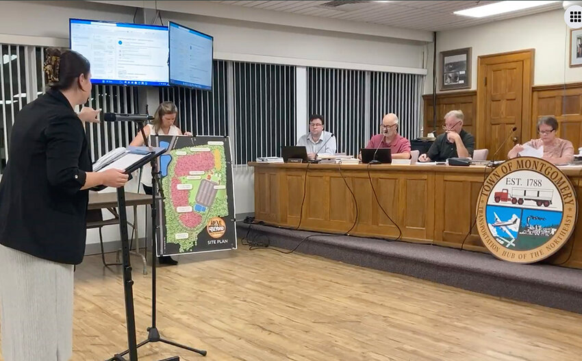 Lara Pruschki (at the podium) and Kelly Naughton (holding the map) describing Forest of Fun Aerial Adventure Park to the planning board.