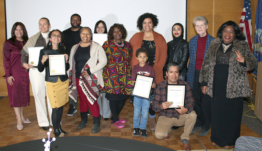 [l-r] The City of Newburgh celebrates its 2024 Human Rights Heroes. Daniella Jackson, Hero Elisabeth Balachova, Hero Betty Bastidas, Kyle Conway, Human Rights Commissioner Liana Rivers, Hero Emily Alta, Human Rights Commissioner Gabrielle Burton-Hill, Hero Stiles Najac, Hero Ignacio Acevedo [kneeling], Human Rights Commissioner Zineb Awad, Human Rights Commissioner Virginia Kasinki and  Thamary Zambuko join together to capture the moment.