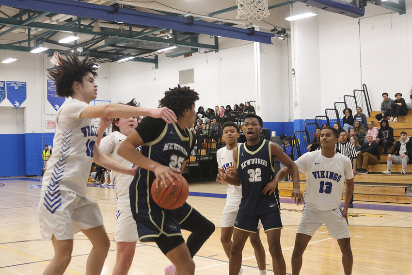 Vikings converge on Newburgh’s Ethan Tyson under the net.