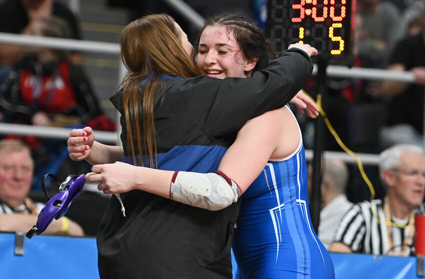 Valley Central’s Arica Pearson-Leary hugs head coach Jen Kinsley after winning a match at the girls’ wrestling state championships on Thursday, Feb. 27.