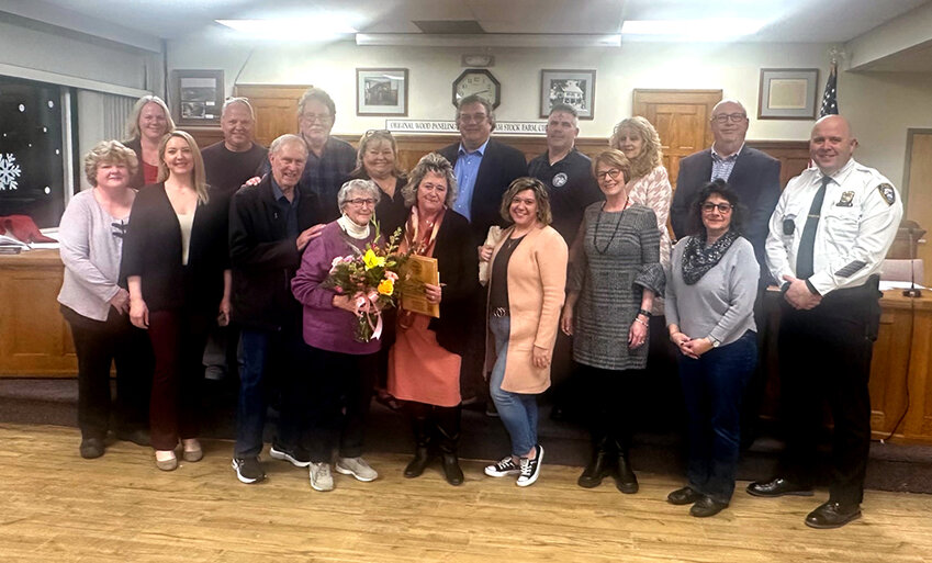 Tara Stickles together the town board, various officials, and her family during her last town board meeting.