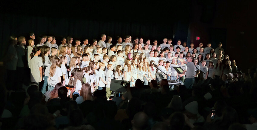 Jodie McCaffrey directing the 4th and 5th grade Choruses.