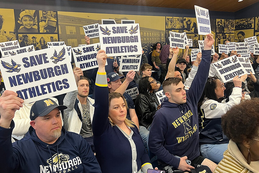 Community members rally at a recent school board meeting.