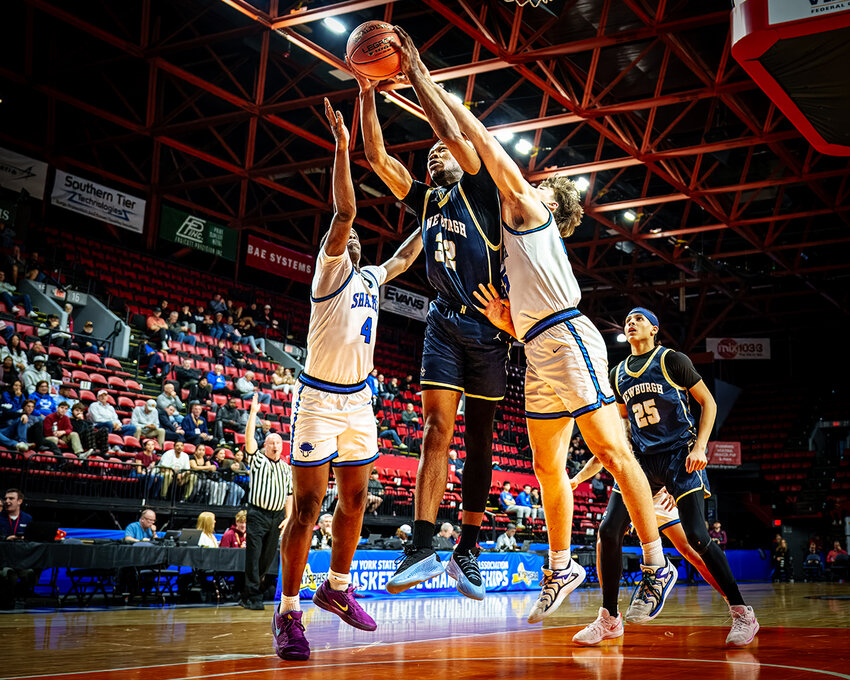 Newburgh’s Bryce Marshall grabs a rebound from Shaker’s Brandon Makovi.