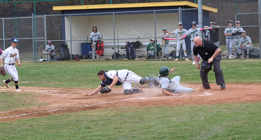 Highland catcher Conor Elliott attempts to tag a FDR baserunner in Thursday’s game.