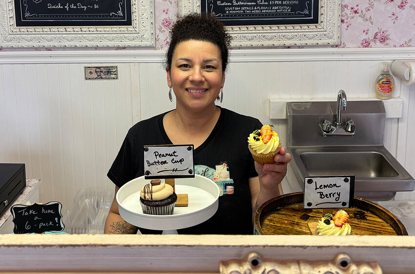 Nicole Conklin, the bakery’s owner, holding up a lemon berry cupcake.