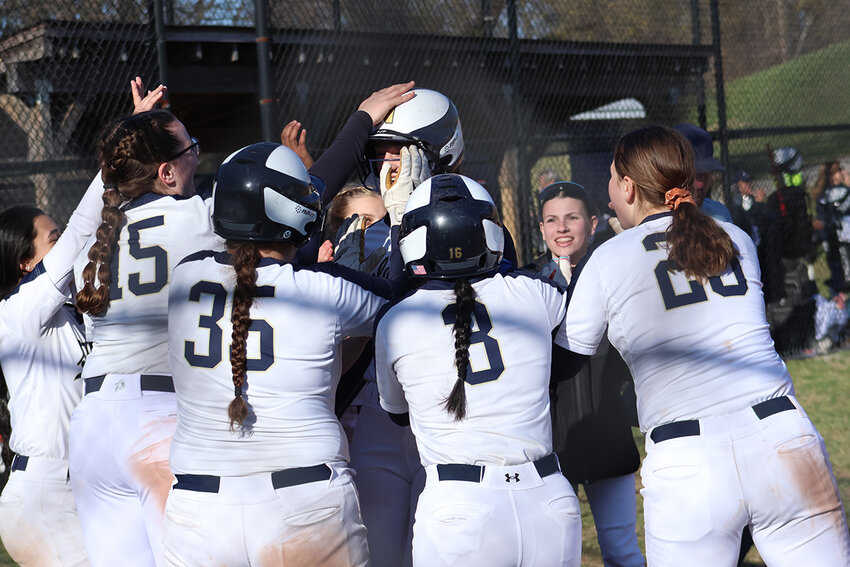 Newburgh’s Melissa Schultze is greeted at home plate after her home run against Pine Bush.