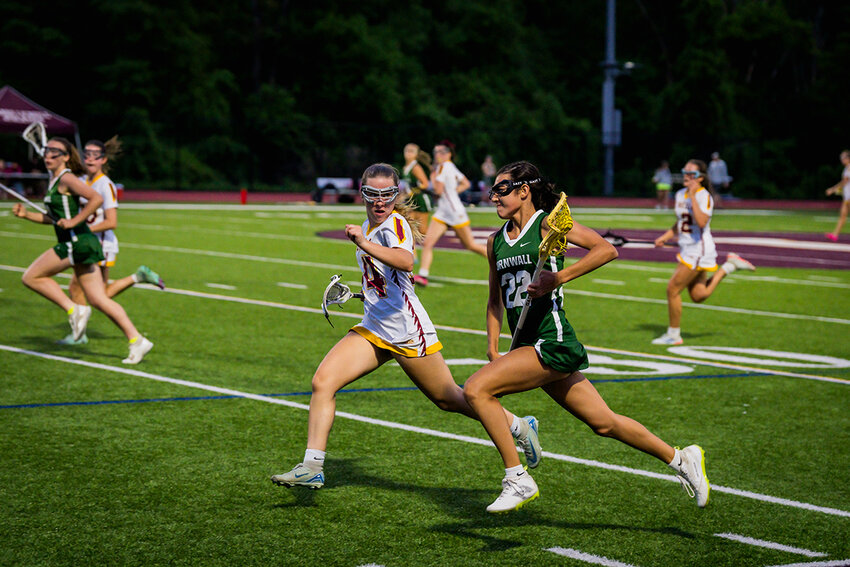 Cornwall’s Kassandra Enos sprints down sideline with ball as O’Neill’s  Kaelyn Mitroka defends.