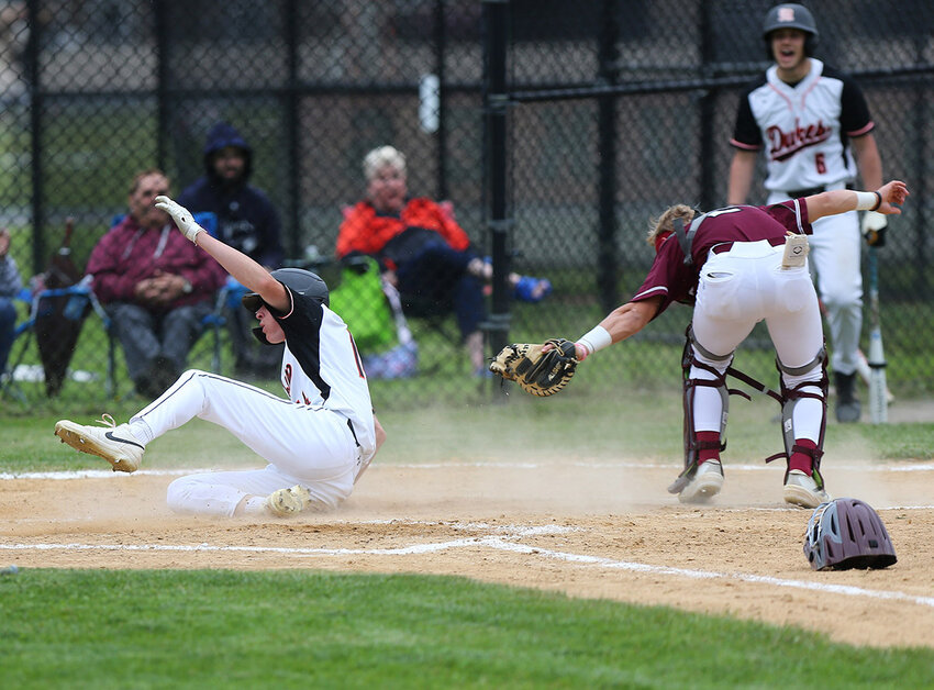 Liam Correa avoids the tag by New Paltz catcher Gavin Treglia and slides home safely on a two run double by Tyson Fernandez in the May 30 semifinal victory.