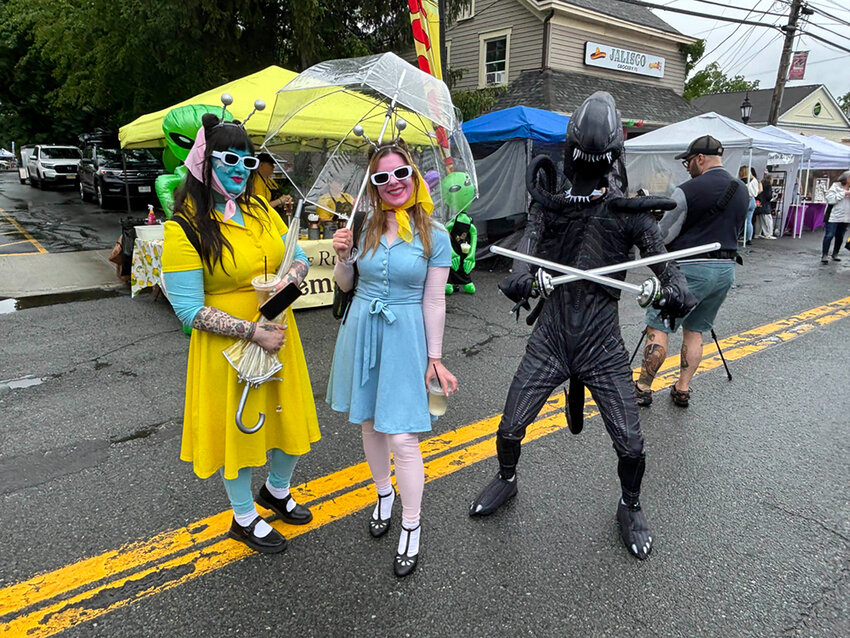 Tracy (left) and Shannon (middle), two “alien” visitors dressed for the beauty pageant. A Xenomorph photobombed the picture last-minute.