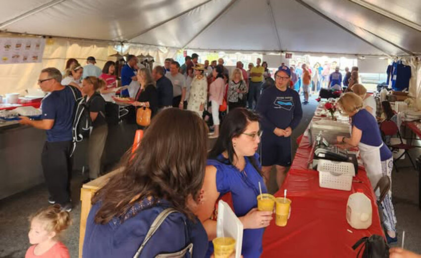 Friends gather under the tent at Fullerton Avenue for the semi-annual Greek Fest.