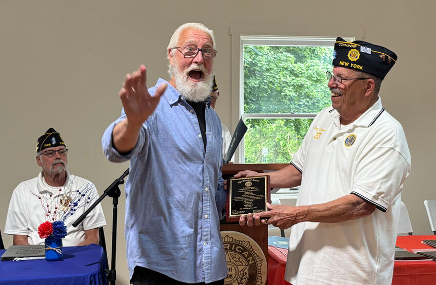 Post 1308 Commander Dan D’ambrozio (right) handing MHI President Robert Glas (left) a plaque commemorating his company’s work on the Post’s meeting hall.