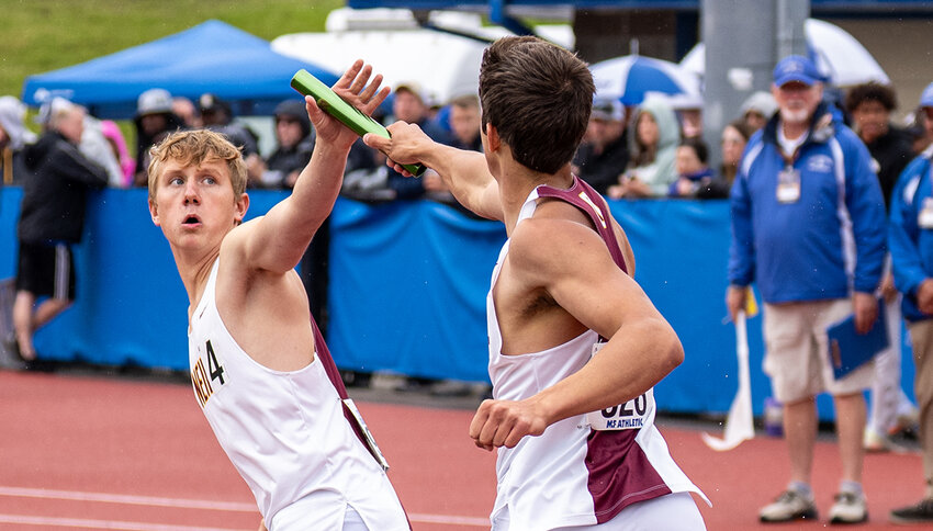 Asher Dabkowski (l.) receives the baton from Dan Bluman in the 4x100 relay.
