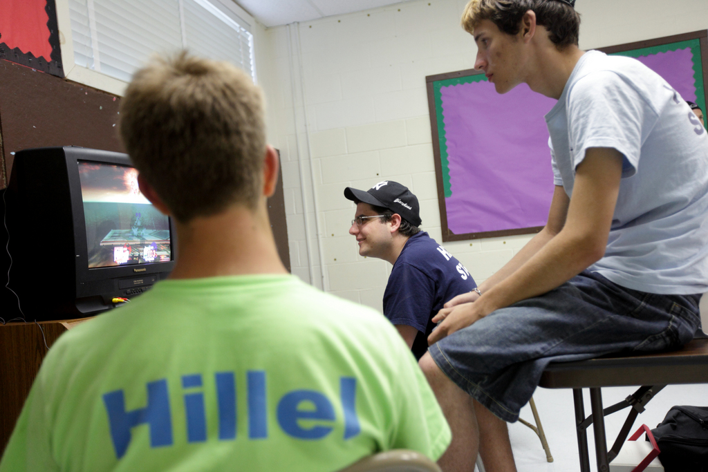 Yigal Rosengarten, 19, center, plays video games with fellow counselor Mark Weingarten, 20, right, and Jack Antilla, 15, at Hillel Day Camp, Thursday, July 22, 2010.