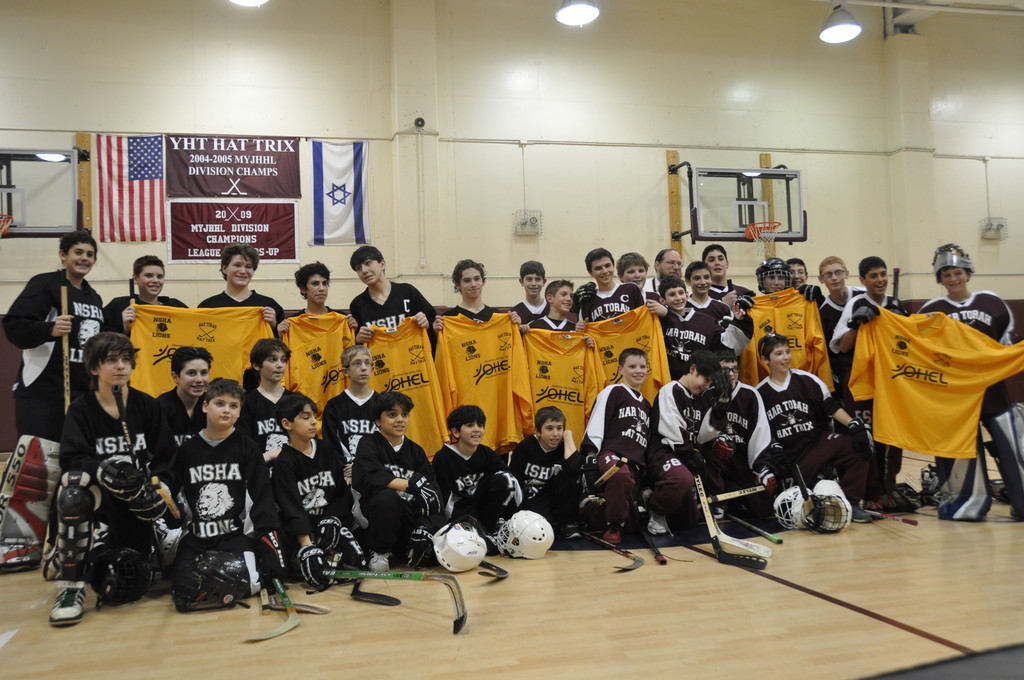 OHEL participants practice hockey alongside the competing school teams