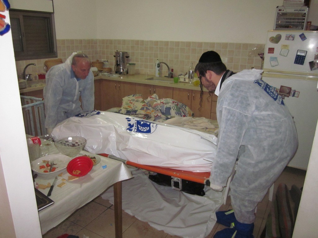 ZAKA volunteers kept vigil over the bodies of the Fogel family during Shabbat, removing them promptly after.