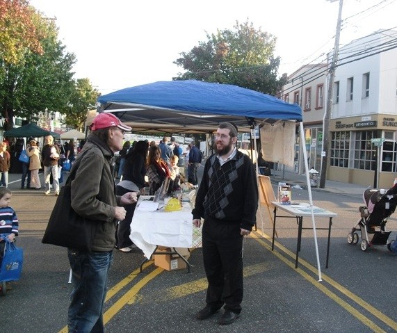 Coinciding with Chol Hamoed Sukkot, the village of Merrick had a street fair on Oct. 16. With temperatures cooling and leaf colors changing, Rabbi Shimon Kramer wore a sweater, handing out calendars, brochures and literature to nearly 200 passersby.