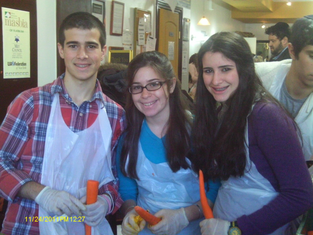 Yaakov Hawk and his sisters Gabrielle and Carrie are among the 200 volunteers who peeled potatoes, sliced carrots and chopped chicken in preparation for Masbia&rsquo;s Thanksgiving dinner.
