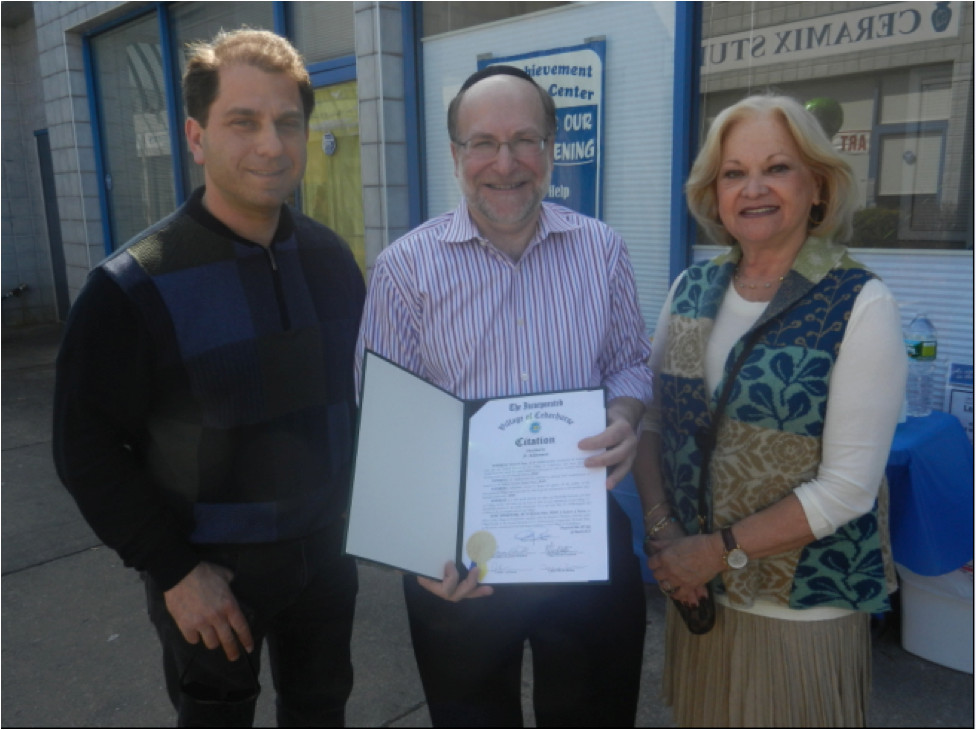 Village of Cedarhurst Trustees Ari Brown and Myrna Zisman present  Cedarhurst merchant Howard Daar of A+ Achievement, Maple Plaza, with a Mayor&rsquo;s Citation at the full service learning center&rsquo;s Grand Opening on March 18.