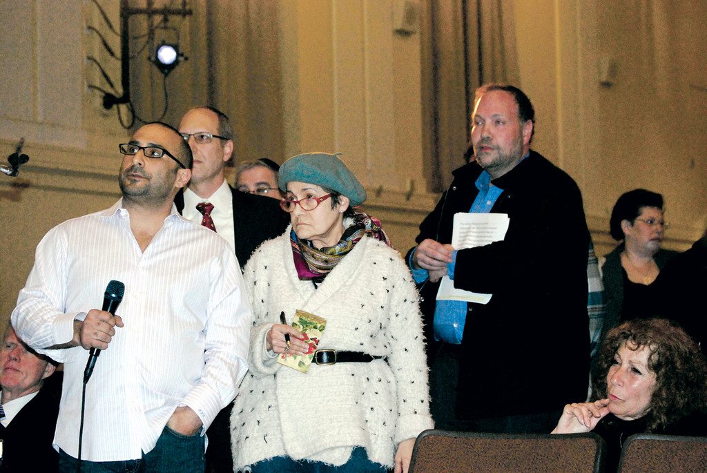 Dror Zar holding microphone, Nidia Mondejar and other residents waited for a response from representatives of Simone Development and Mt. Sinai at a town hall meeting on Feb. 27.