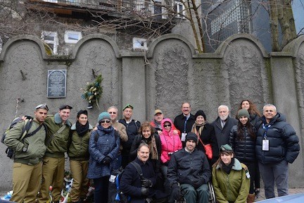 A group of FIDF delegation participants and IDF soldiers, with FIDF National President, Julian Josephson and FIDF National Director and CEO, Maj. Gen. (Res.)Yitzhak (Jerry) Gershon, at the remnants of the Krakow Ghetto Wall.